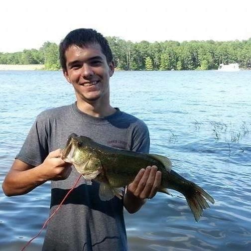Dusty Lane holding a bass fish